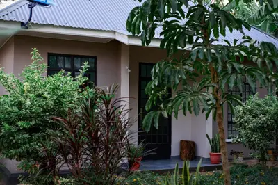a house with plants in front of it at Mesa Home Apartment in Arusha