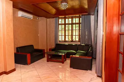 a living room with a couch and a table at Hotel Graceland Arusha in Arusha