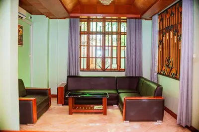 a living room with a couch and a table at Hotel Graceland Arusha in Arusha