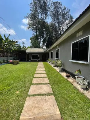 a backyard of a house with a grass yard at Casa Mianzini in Arusha