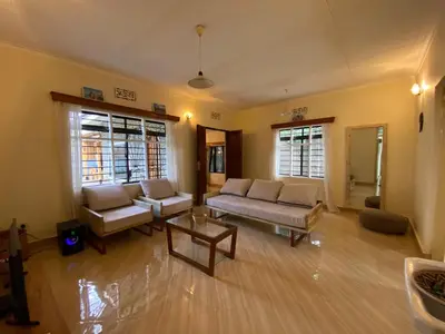 a living room with two couches and a table at Casa Mianzini in Arusha