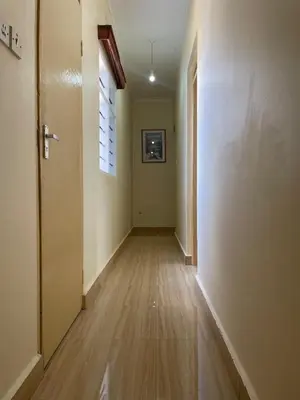 an empty hallway with a door and a window at Casa Mianzini in Arusha