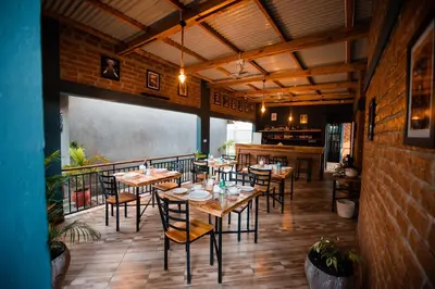 a restaurant with tables and chairs in a room at Katiti Lodge in Arusha