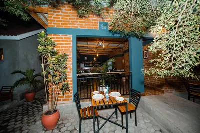 a table and chairs in front of a building at Katiti Lodge in Arusha