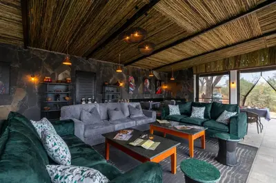 a living room with green couches and tables at Tarangire Elephant Springs in Engassumet
