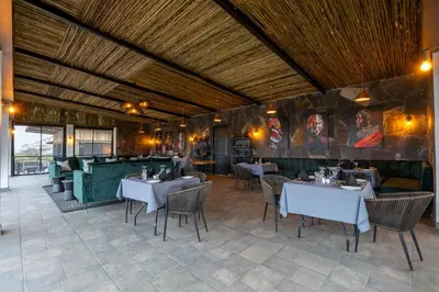 a dining room with tables and chairs in a restaurant at Tarangire Elephant Springs in Engassumet