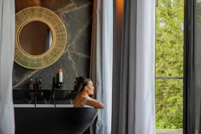 a woman in a bath tub in a window at Tarangire Elephant Springs in Engassumet