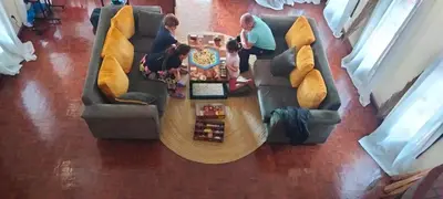 a group of people sitting around a table on a couch at Hansat Homestay Residence in Arusha