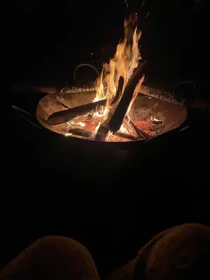 a fire in a grill with some food in it at Hansat Homestay Residence in Arusha