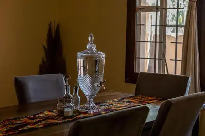 a dining room table with a glass lantern on it at Hansat Homestay Residence in Arusha