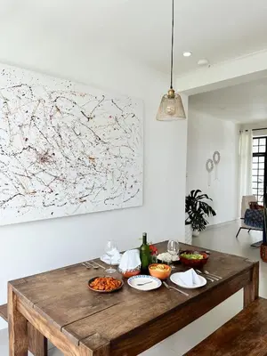 a wooden table with food on it in a living room at Ndani House in Arusha