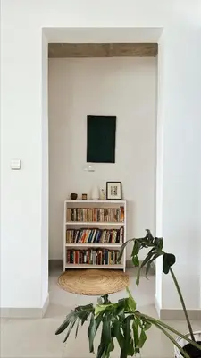 a living room with a book shelf with books at Ndani House in Arusha