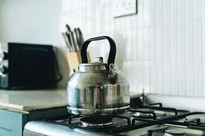 a tea kettle sitting on top of a stove at Ndani House in Arusha