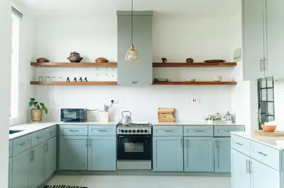 a kitchen with blue cabinets and a stove at Ndani House in Arusha