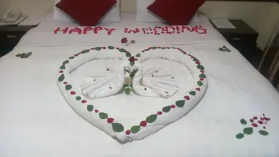 a cake in the shape of a heart on a bed at The Charity Hotel International in Arusha