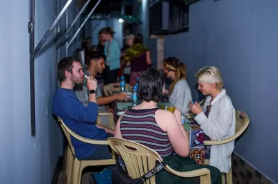 a group of people sitting at a table in a restaurant at Hecasa Apartments in Arusha