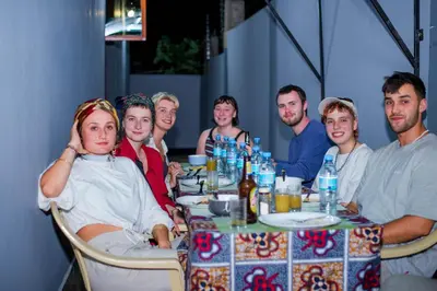 a group of people sitting at a table at Hecasa Apartments in Arusha