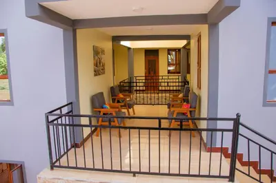 a hallway with chairs and tables in a building at Hecasa Apartments in Arusha