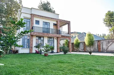 a large house with a lawn in front of it at Elmitho House in Arusha