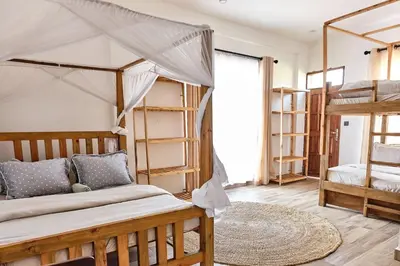 a bedroom with two bunk beds and a rug at Elmitho House in Arusha