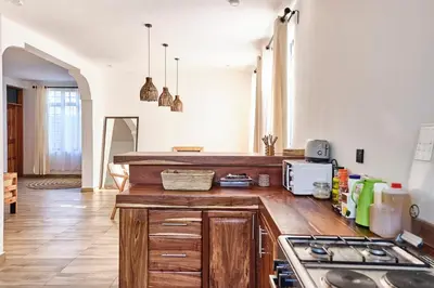 a kitchen with wooden cabinets and a counter top at Elmitho House in Arusha