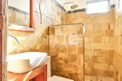 a bathroom with a sink and a shower at Elmitho House in Arusha