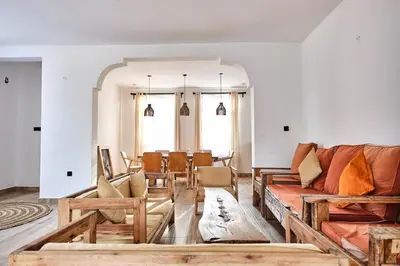 a living room with a couch and a table at Elmitho House in Arusha