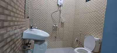 a bathroom with a shower and a toilet and a sink at Lasts minute lodge in Boma la Ngombe