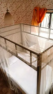 a bunk bed in a room with white sheets at karibu la kossa in Tuvaila