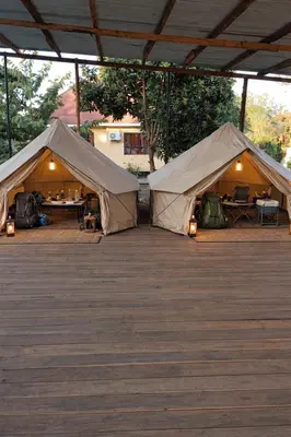 two large tents sitting on a wooden deck at karibu la kossa in Tuvaila