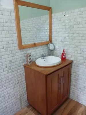 a bathroom with a sink and a mirror at Rau River House - Moshi in Msaranga