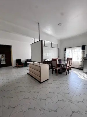 a living room with a table and a dining room at Maya in Arusha