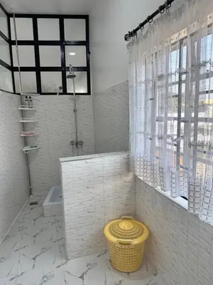 a bathroom with a shower and a sink and a toilet at Maya in Arusha