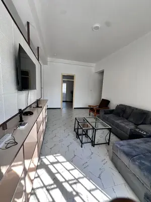 a living room with a couch and a tv at Maya in Arusha
