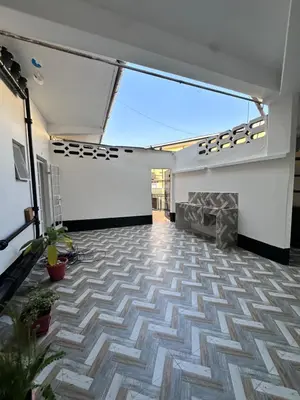 an empty room with a fireplace and a vaulted ceiling at Maya in Arusha