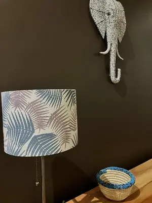a room with a lamp and an elephant on the wall at Allamanda House Meru in Arusha