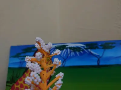 a vase with white flowers and a giraffe at Sero Safaris Hostel in Arusha