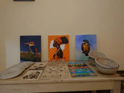 a wooden table with paintings of birds on it at Sero Safaris Hostel in Arusha