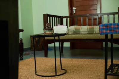 a table with a cake on it next to a bed at Mesa, Mama Ket Homes Arusha in Arusha