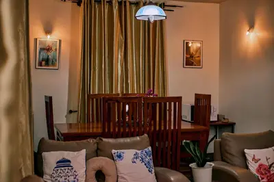 a living room with a couch and a table at Mesa, Mama Ket Homes Arusha in Arusha