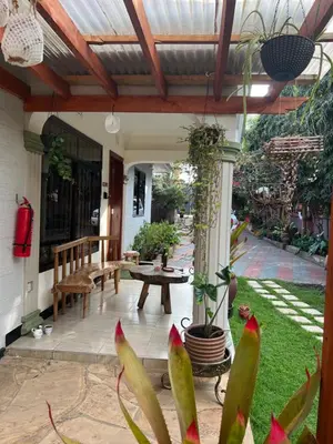 a covered patio with a table and a bench at Lavish luxury homes in Nkoanrua
