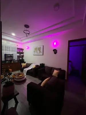 a living room with purple lights and a couch at Lavish luxury homes in Nkoanrua