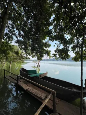 a boat parked next to a dock on a lake at Lavish luxury homes in Nkoanrua
