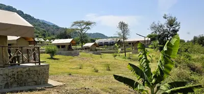 a view of a village with houses and a field at Africa Safari Rift Valley Camping in Magara