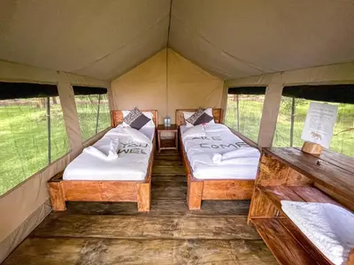 a room with two beds in a tent at Africa Safari Rift Valley Camping in Magara