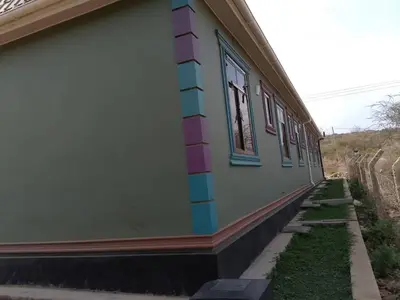 a building with colored stripes on the side of it at Dangote Farm House Eyasi in Mangola