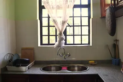 a kitchen counter with a sink and a window at My Moka Arusha in Arusha