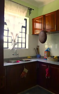 a kitchen with a sink and a window at My Moka Arusha in Arusha