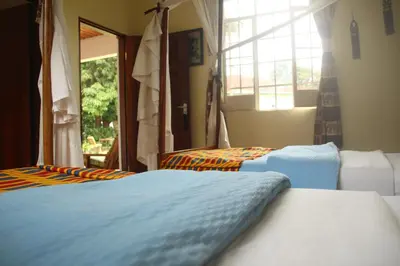 a bedroom with two beds and a window at Marangu Hotel in Marangu