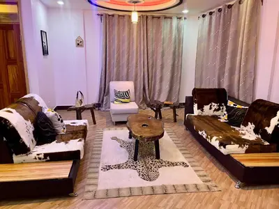 a living room with couches and a coffee table at SandS Escape in Arusha